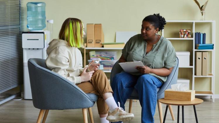 two females sitting chatting